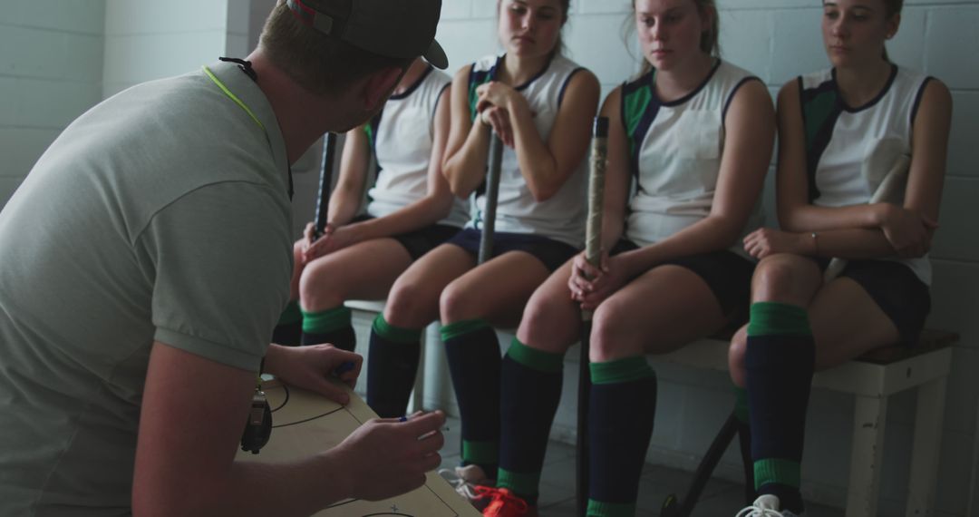 Female Field Hockey Team Getting Instructions from Coach in Locker Room - Free Images, Stock Photos and Pictures on Pikwizard.com