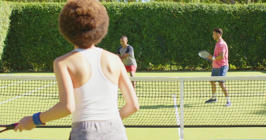 Friends Enjoying Tennis Match on Sunny Day - Free Images, Stock Photos and Pictures on Pikwizard.com