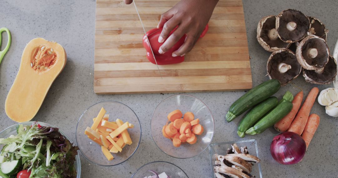 Person Slicing Red Pepper with Fresh Veggies on Tabletop - Free Images, Stock Photos and Pictures on Pikwizard.com