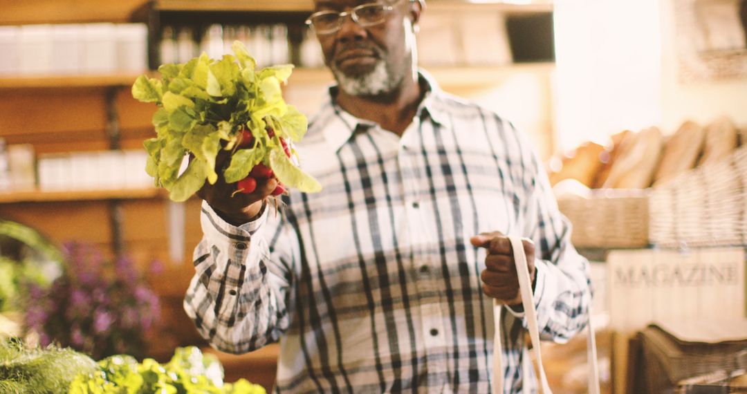 Older African American Man Buying Fresh Vegetables at Market - Free Images, Stock Photos and Pictures on Pikwizard.com