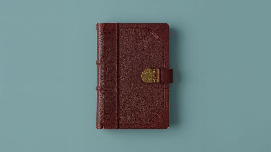 Leather-Bound Notebook with Gold Clasp on Blue Surface