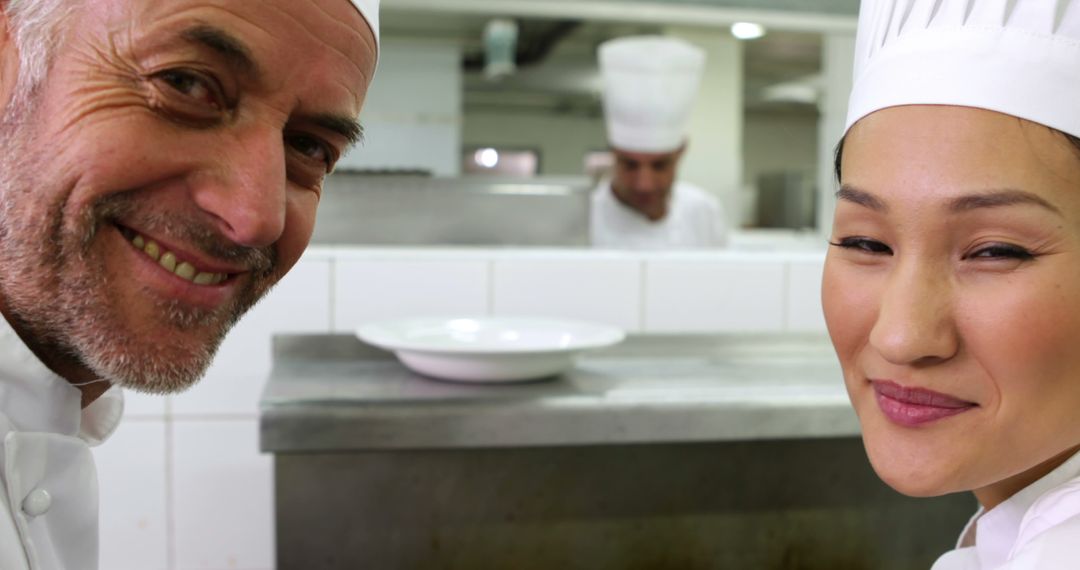 Smiling Chefs in Professional Kitchen Workplace - Free Images, Stock Photos and Pictures on Pikwizard.com