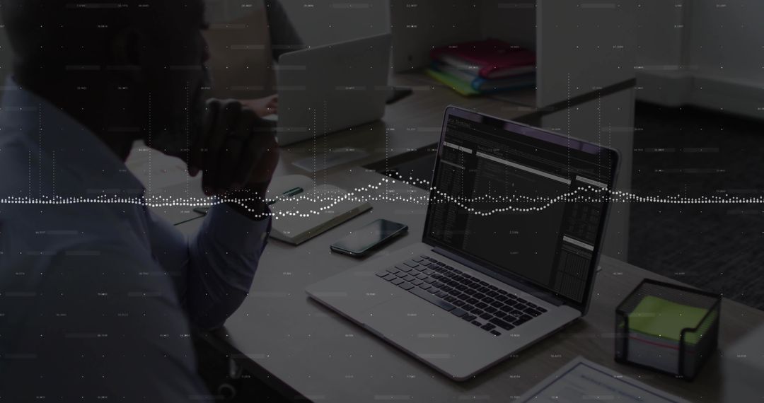 Business Professional Analyzing Data on Laptop at Modern Office