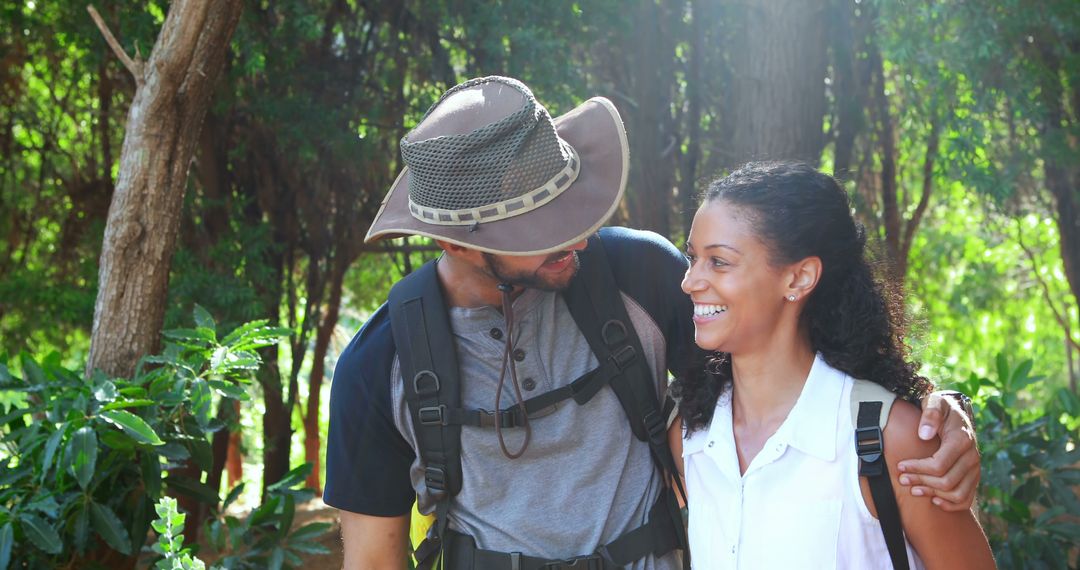 Couple Enjoying a Hike in a Sunlit Forest