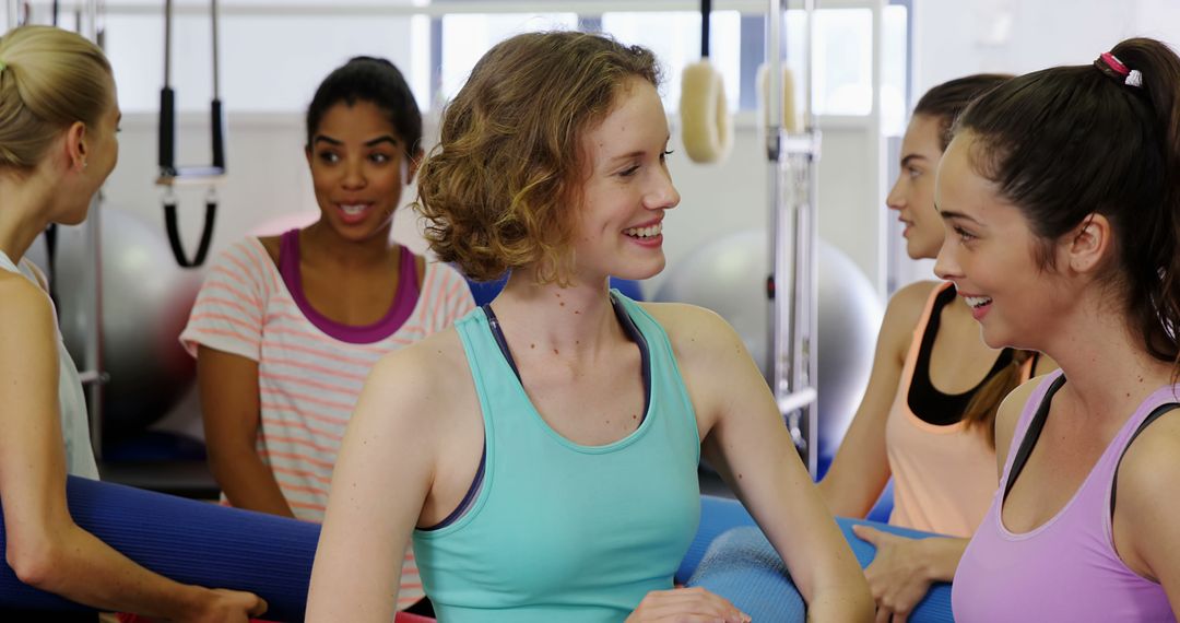 Group of Women Enjoying Pilates Class, Laughing and Conversing - Free Images, Stock Photos and Pictures on Pikwizard.com