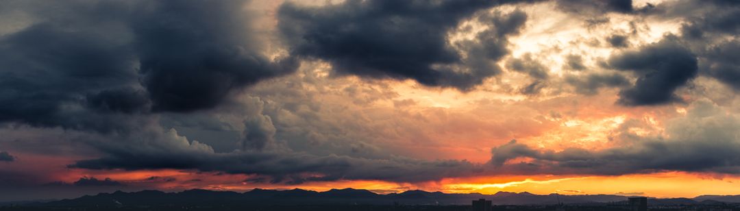 Dramatic Sunset Over Mountain Range with Dark Storm Clouds - Free Images, Stock Photos and Pictures on Pikwizard.com