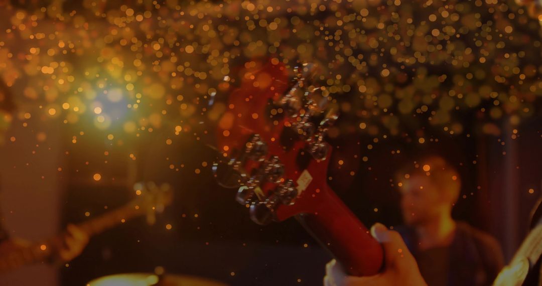 Electric Guitar Performance with Golden Bokeh in Concert