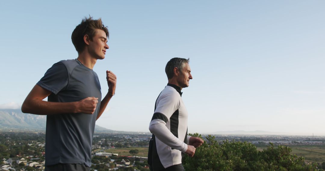 Father and Son Jogging Together Outdoors on Scenic Path - Free Images, Stock Photos and Pictures on Pikwizard.com