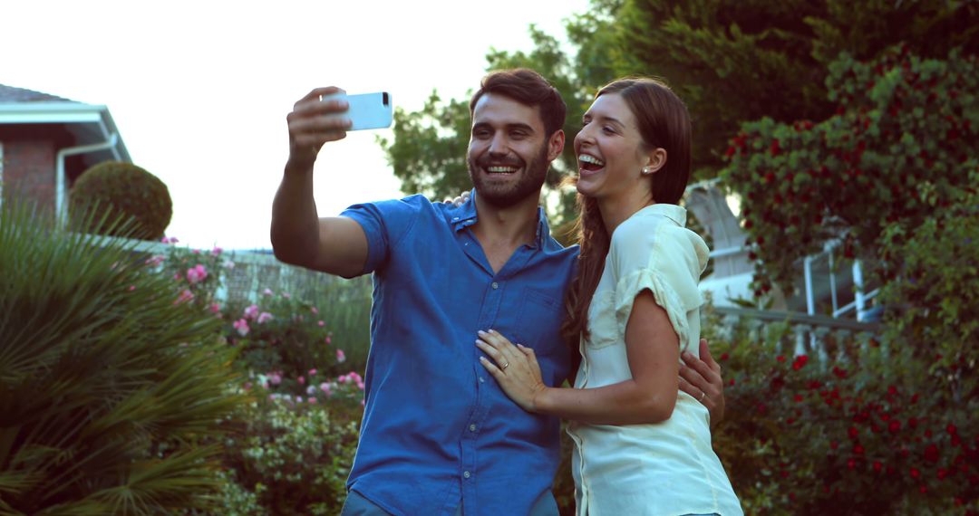 Couple Enjoying a Sunny Day by Taking Selfie in Garden