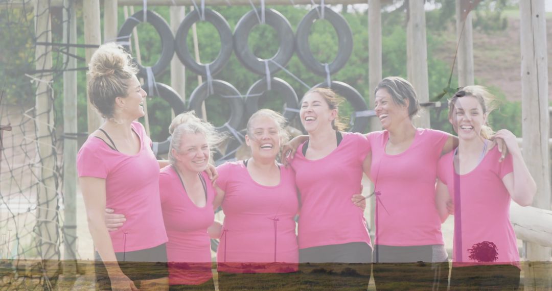 Group of Women Embracing Each Other at Outdoor Obstacle Course