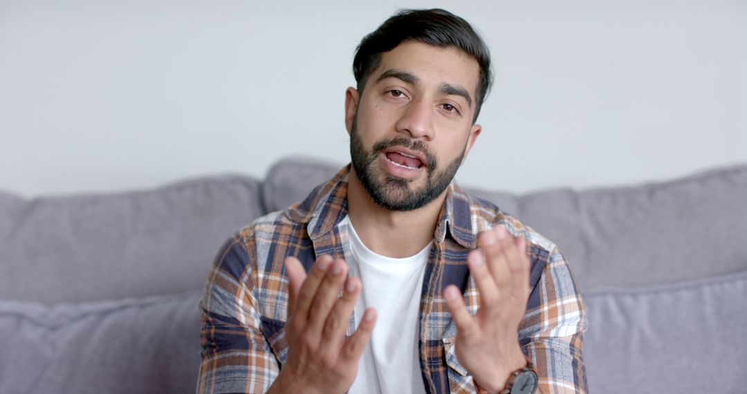 Young Asian Man Engaged in Casual Video Call at Home