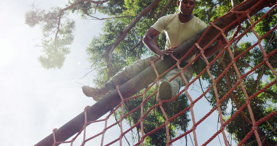 Man Overcoming Outdoor Obstacle Course Challenge