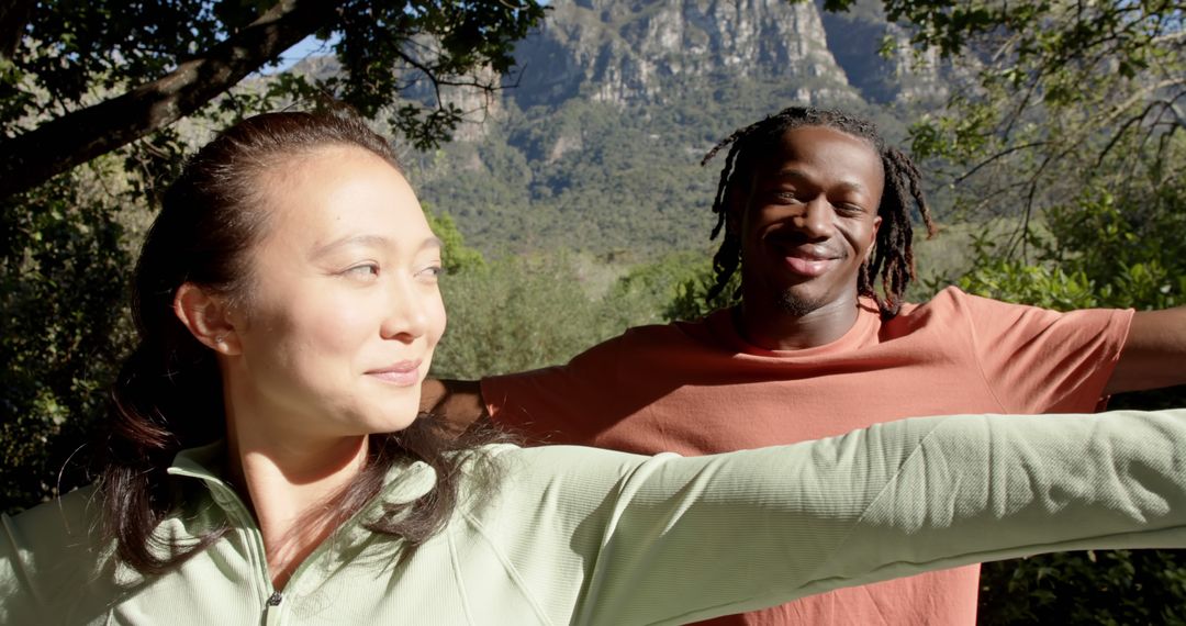 Interracial Couple Enjoying Outdoor Yoga in Mountainous Landscape - Free Images, Stock Photos and Pictures on Pikwizard.com