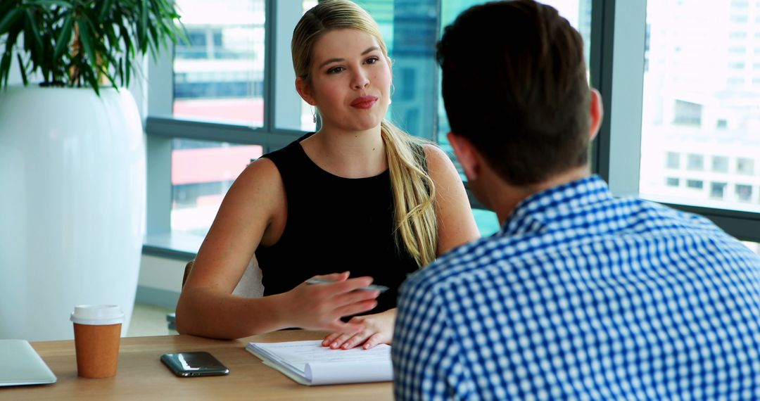 Woman in Professional Attire Interviewing Candidate in Office - Free Images, Stock Photos and Pictures on Pikwizard.com