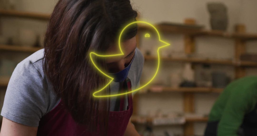 Female Potter Shaping Clay in Artisan Studio Setting