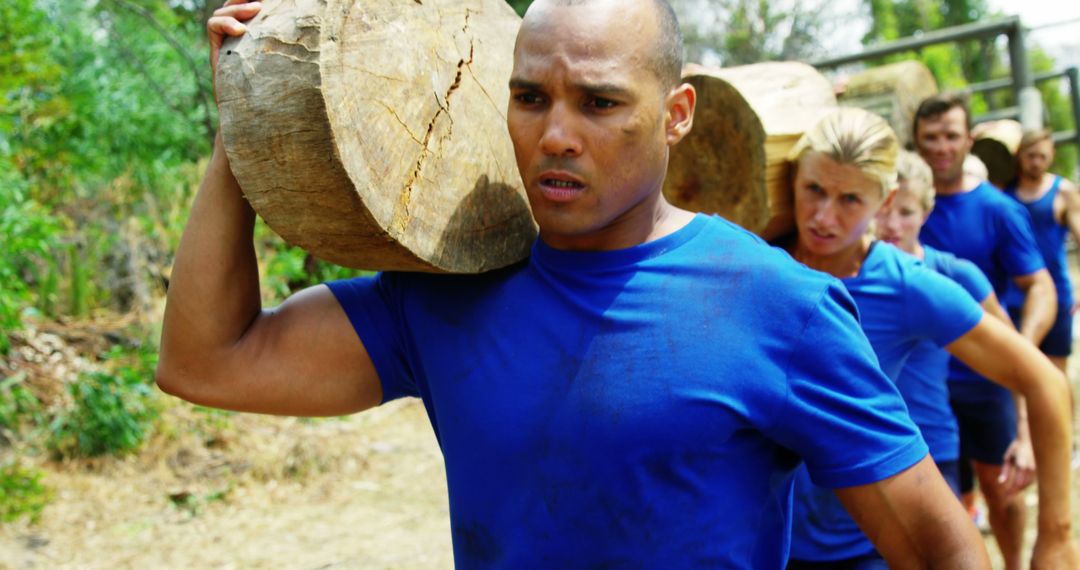 Diverse Group Crushing Outdoor Log Carrying Fitness Challenge