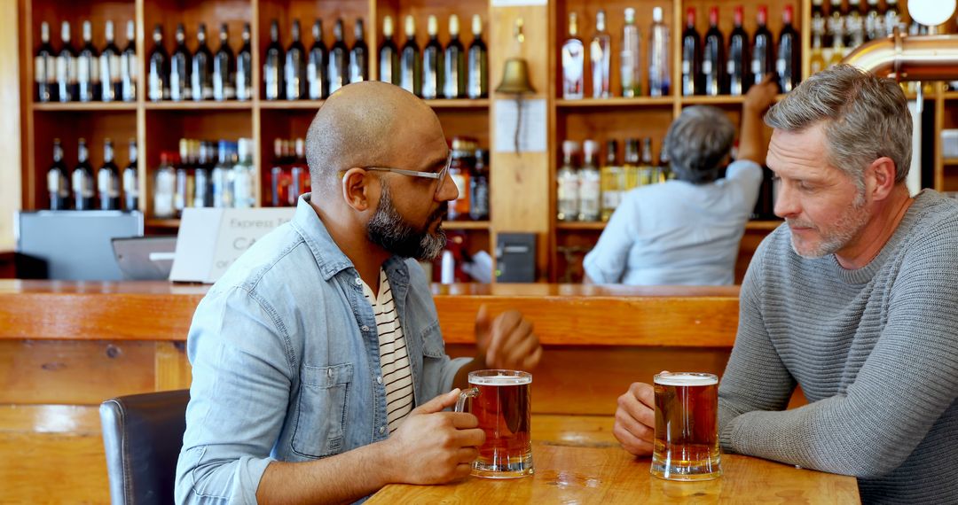 Two Friends Enjoy Conversation Over Drinks at Bar