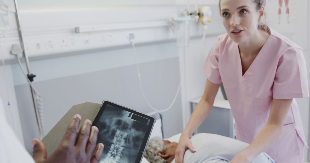 Nurse examining elderly patient with doctor reviewing X-ray in hospital - Free Images, Stock Photos and Pictures on Pikwizard.com