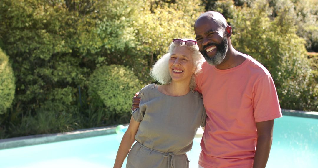 Senior Friends Smiling by Pool on Sunny Day