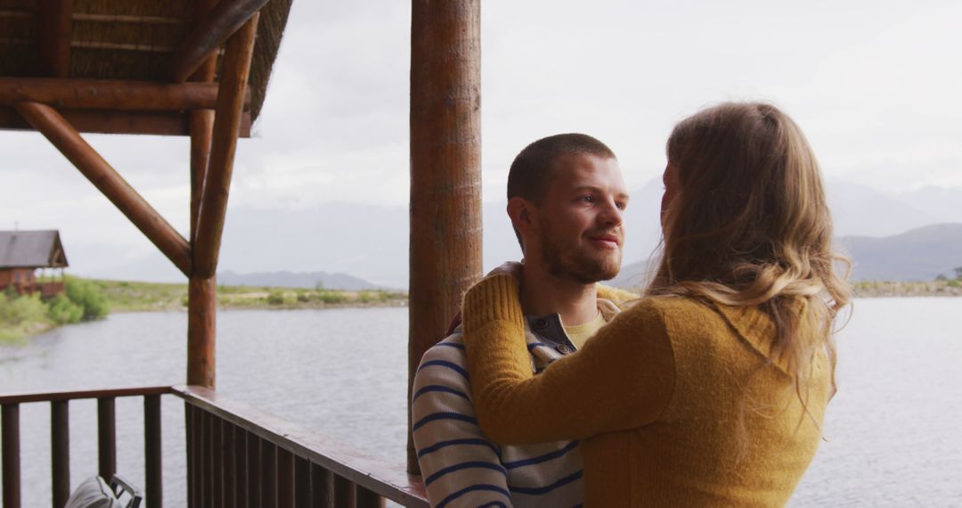 Loving Couple Embracing On Wooden Porch By Lake - Free Images, Stock Photos and Pictures on Pikwizard.com