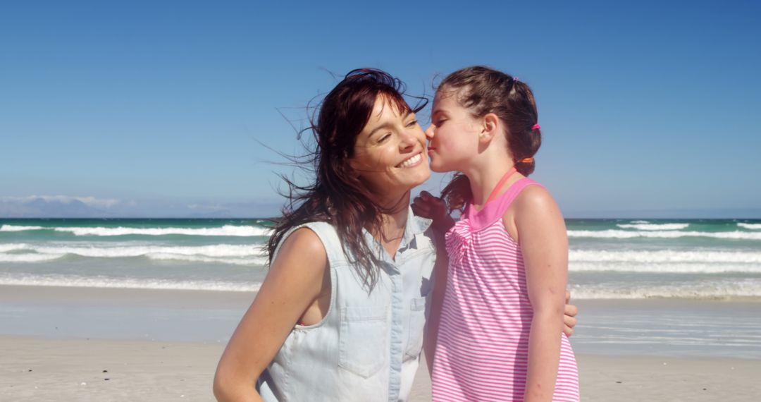 Smiling Daughter Kissing Mother on Beach - Free Images, Stock Photos and Pictures on Pikwizard.com