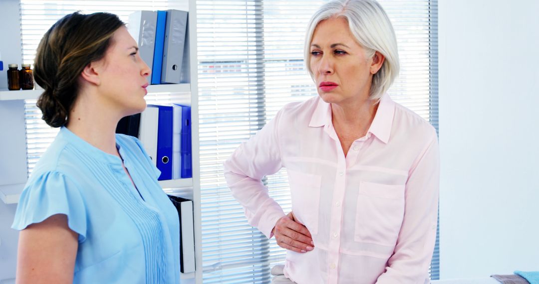 Healthcare professional examining patient with abdominal pain - Free Images, Stock Photos and Pictures on Pikwizard.com