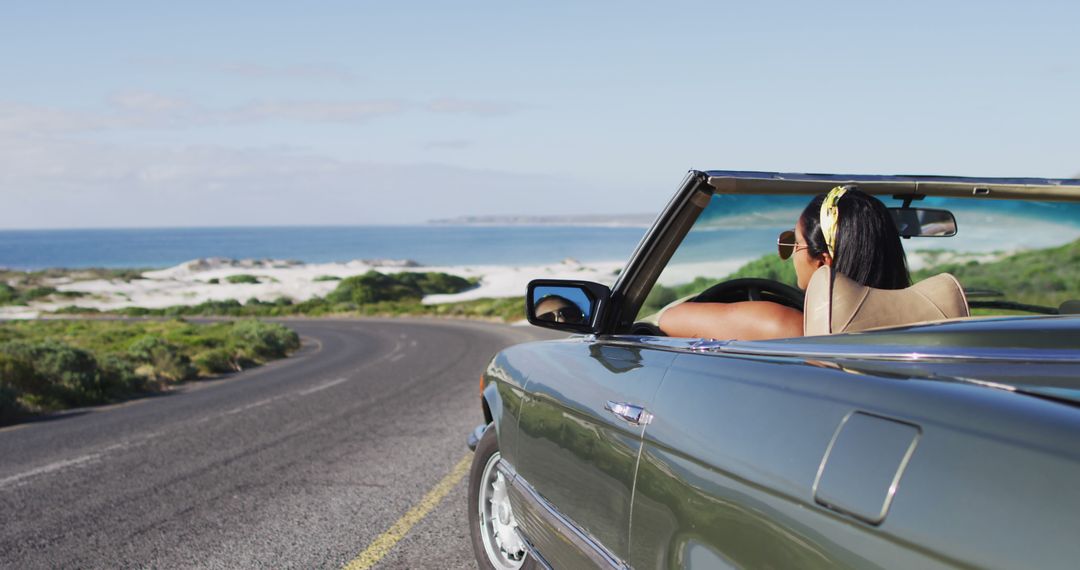 Woman Driving Convertible on Coastal Highway with Ocean View - Free Images, Stock Photos and Pictures on Pikwizard.com