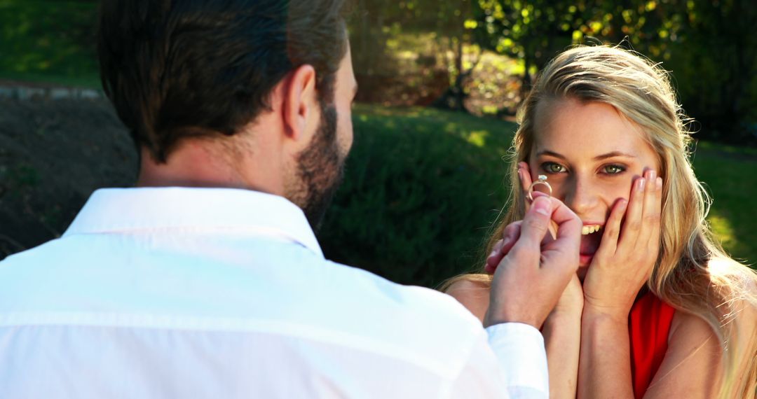Man Proposing Marriage with Ring to Surprised Woman in Garden - Free Images, Stock Photos and Pictures on Pikwizard.com