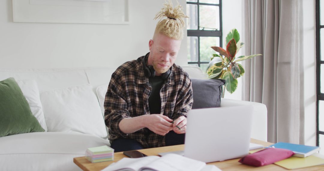 Albino Man in Casual Clothes Working Remotely with Laptop in Home Office - Free Images, Stock Photos and Pictures on Pikwizard.com