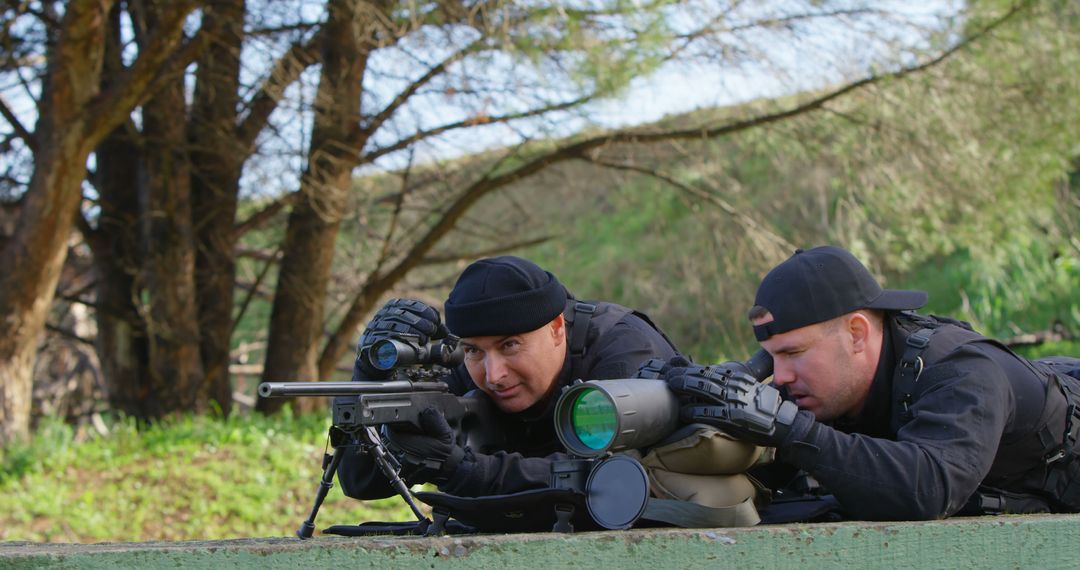 Two Soldiers Using Sniper Equipment in Forest Clearing - Free Images, Stock Photos and Pictures on Pikwizard.com