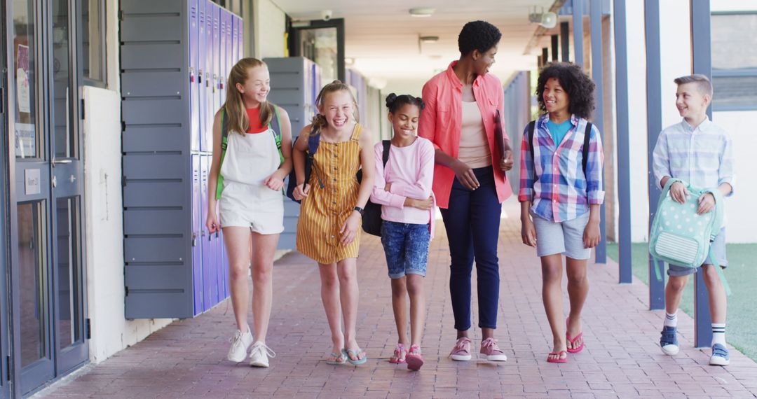 Teacher Walking with Diverse Students in School Corridor