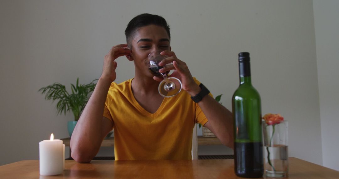 Young Man Enjoying Red Wine During Dinner - Free Images, Stock Photos and Pictures on Pikwizard.com