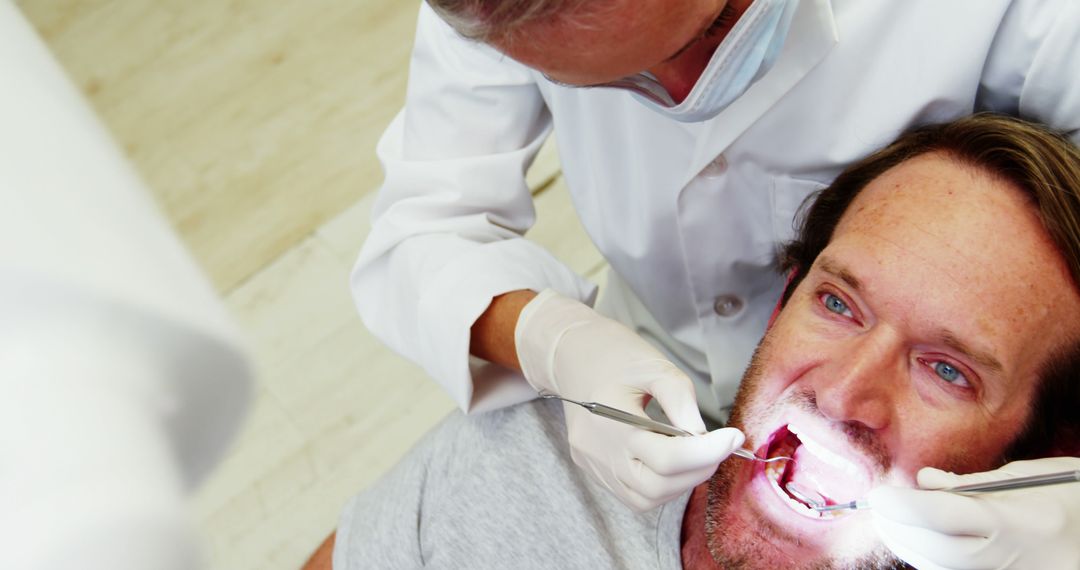 Dentist Examining Patient's Teeth During Routine Checkup - Free Images, Stock Photos and Pictures on Pikwizard.com