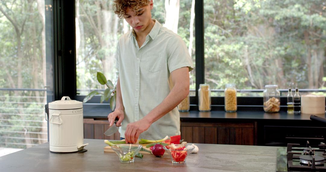 Man Prepares Fresh Vegetables in Modern Sunlit Kitchen
