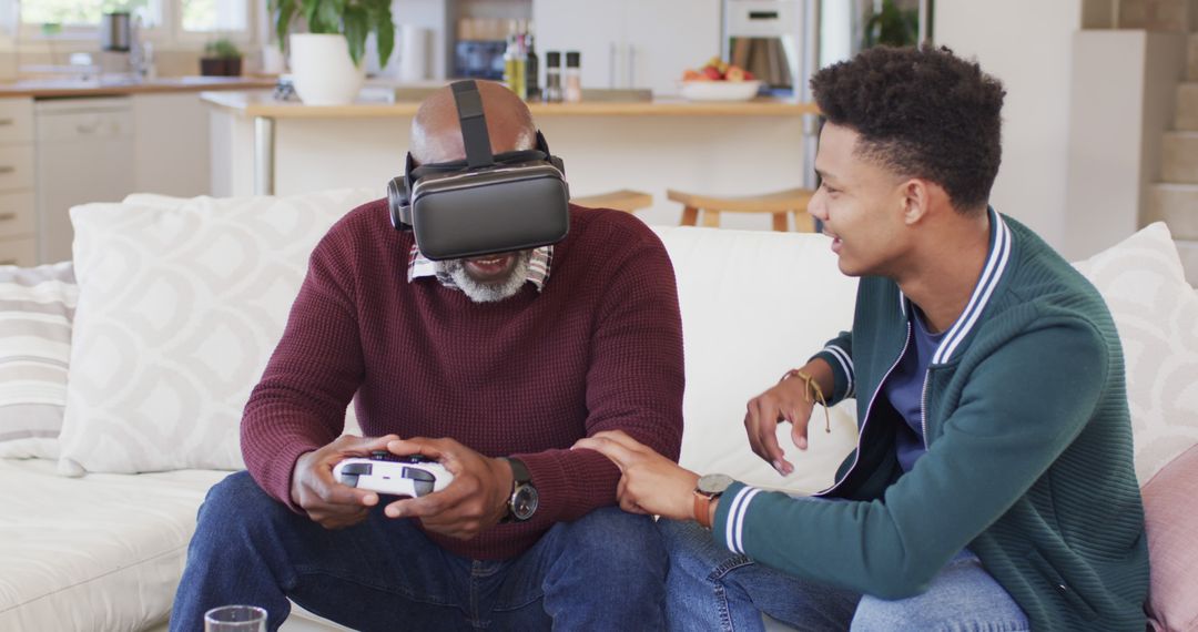 Elderly Man Using VR Headset with Assistance of Younger Man on Couch - Free Images, Stock Photos and Pictures on Pikwizard.com