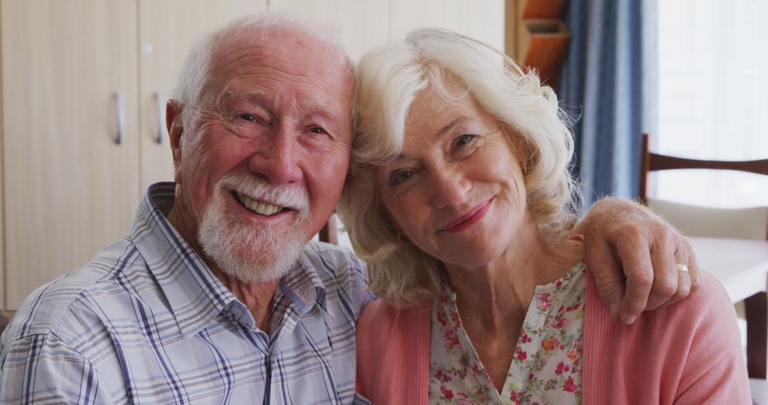 Smiling Senior Couple Embracing in Cozy Home Setting