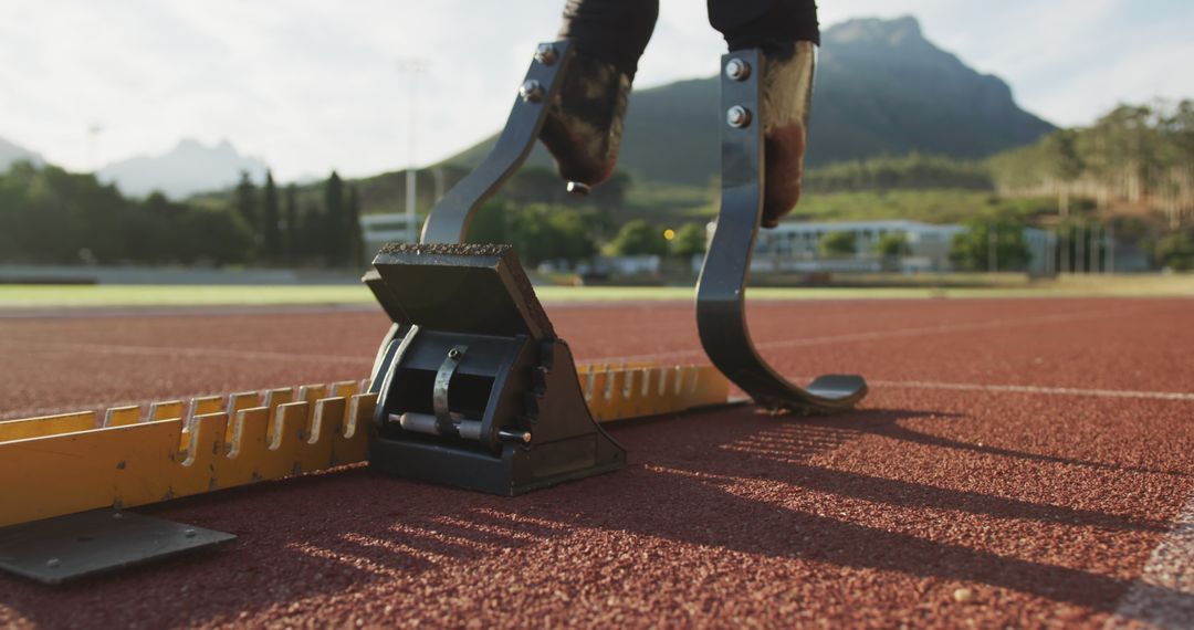 Paralympic athlete with prosthetic blades at running starting blocks - Free Images, Stock Photos and Pictures on Pikwizard.com