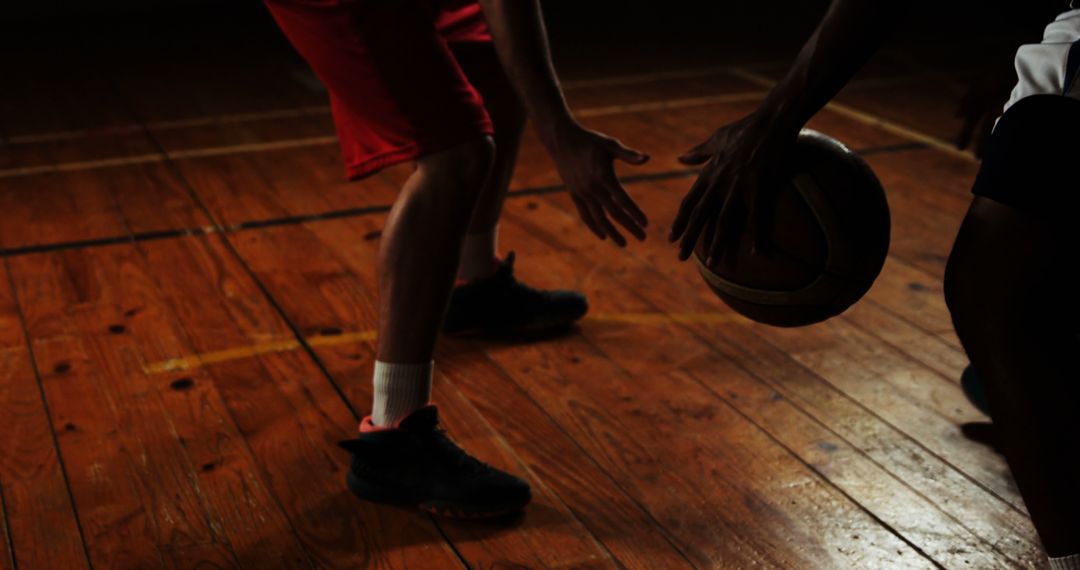 Intense Basketball Game Action on Wooden Court Surface