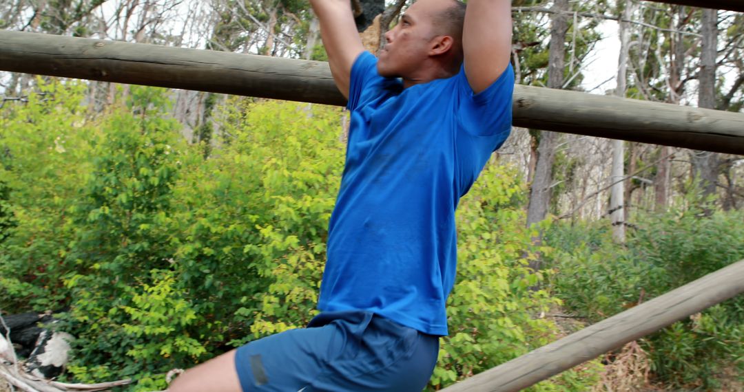 Man in Blue Shirt Exercising on Outdoor Monkey Bars - Free Images, Stock Photos and Pictures on Pikwizard.com