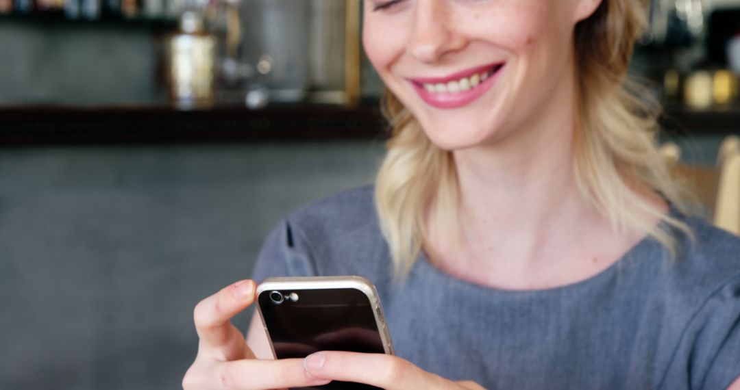 Smiling Woman Using Smartphone Indoors - Free Images, Stock Photos and Pictures on Pikwizard.com