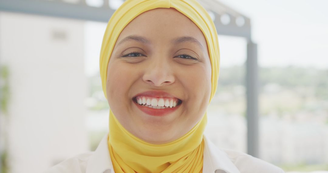 Smiling Woman in Yellow Hijab Displaying Joy - Free Images, Stock Photos and Pictures on Pikwizard.com