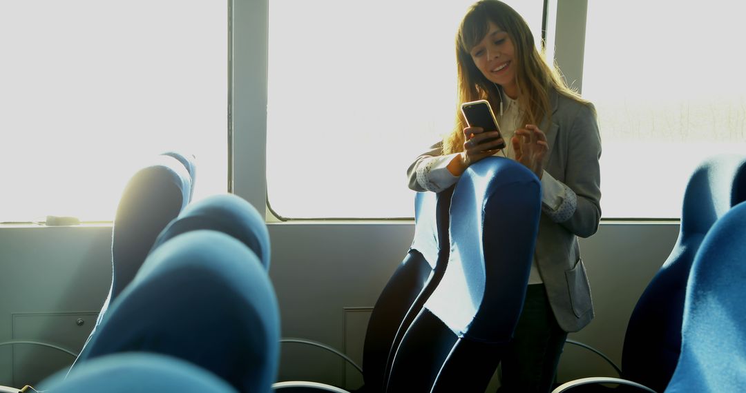 Businesswoman on commuter train using smartphone during morning - Free Images, Stock Photos and Pictures on Pikwizard.com