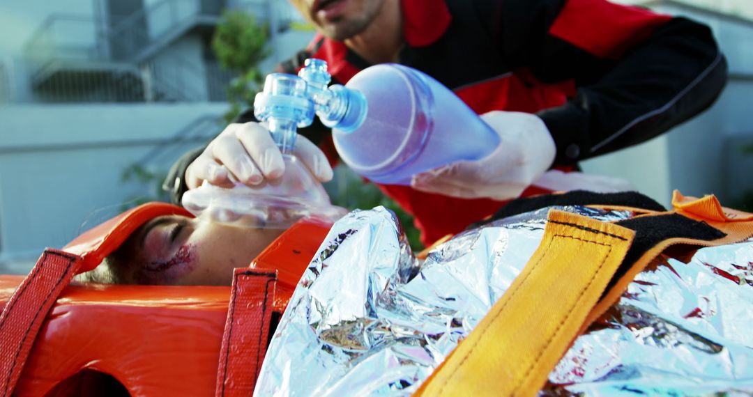 Emergency Medical Technician Providing Oxygen to Injured Patient - Free Images, Stock Photos and Pictures on Pikwizard.com