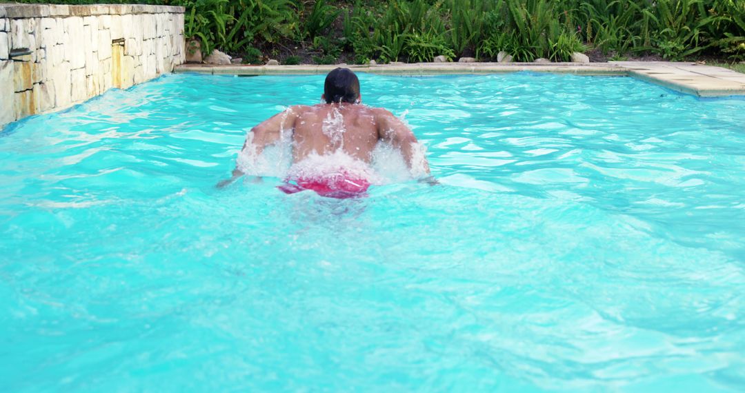 Man Swimming in Outdoor Pool with Clear Water - Free Images, Stock Photos and Pictures on Pikwizard.com