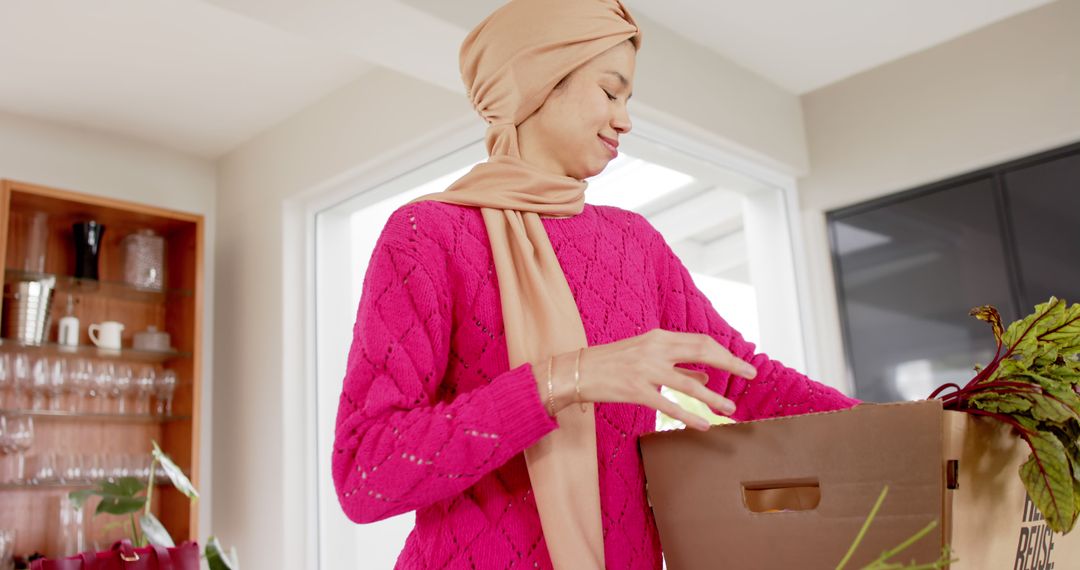 Smiling Woman in Hijab Unpacking Fresh Groceries in Modern Kitchen - Free Images, Stock Photos and Pictures on Pikwizard.com