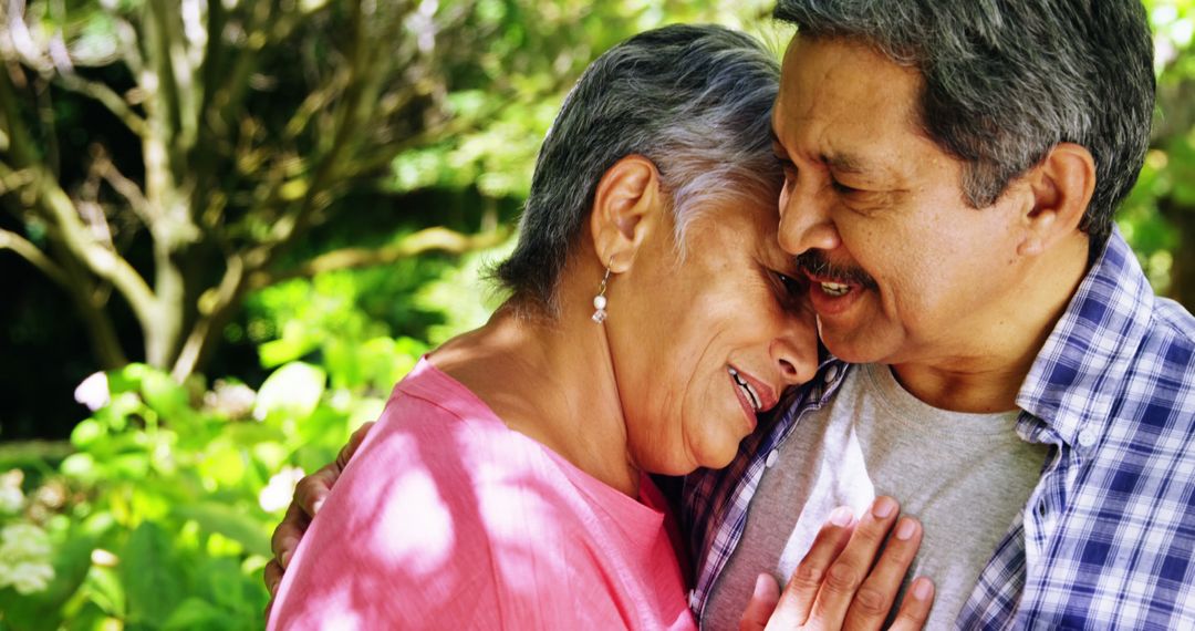 Loving Senior Couple Embracing in Lush Garden