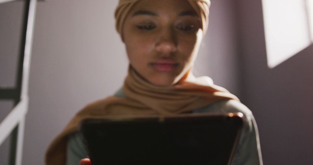 Young Woman Wearing Hijab Using Digital Tablet Indoors - Free Images, Stock Photos and Pictures on Pikwizard.com