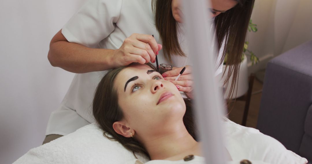 Woman Receiving Eyebrow Shaping and Styling at Beauty Salon - Free Images, Stock Photos and Pictures on Pikwizard.com