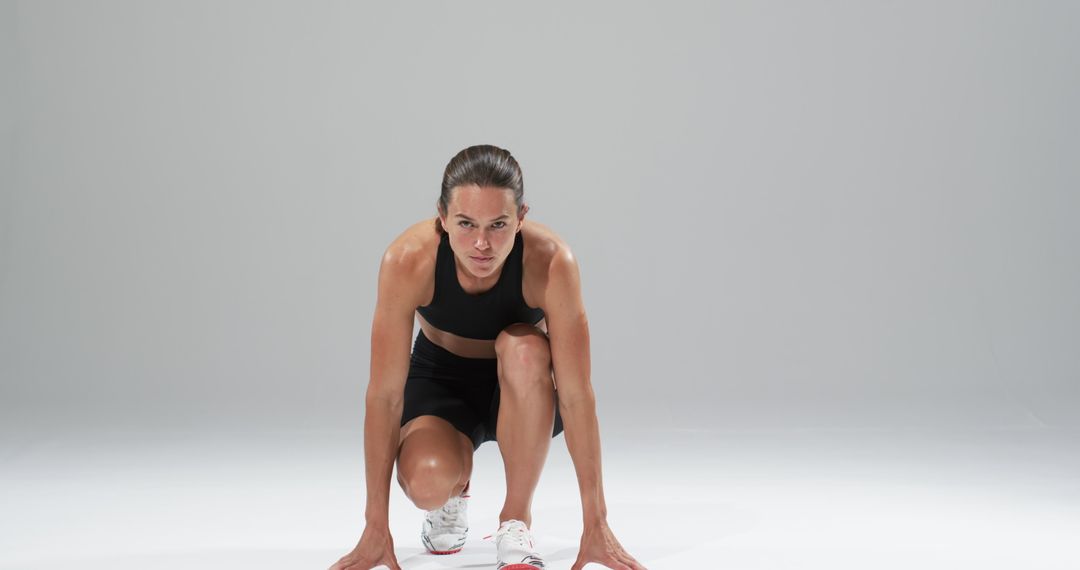 Athlete Focused on Sprint Start in Minimalist White Space