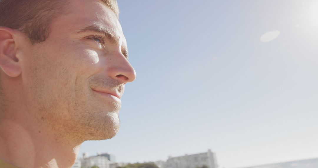 Smiling Man Enjoying Bright Sunny Day Outdoors - Free Images, Stock Photos and Pictures on Pikwizard.com